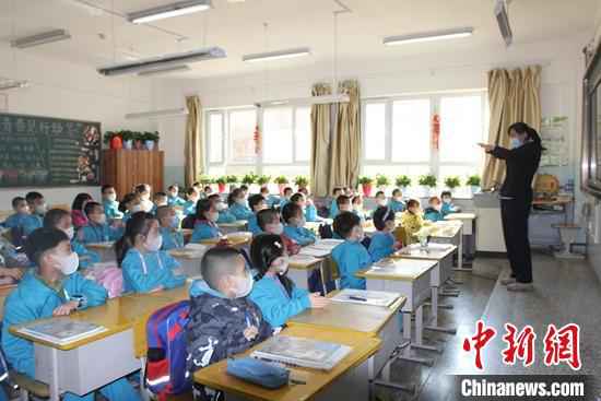 乌鲁木齐市第一小学开学第一天,学生们带着口罩听讲。 陶拴科 摄  新疆中小学和中职学校全面开学复课